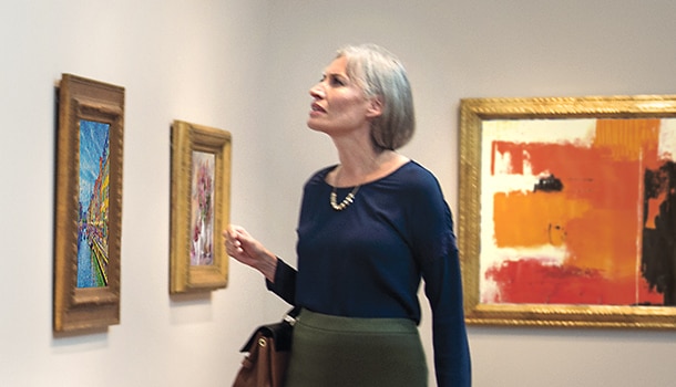 A woman looking at art in a gallery