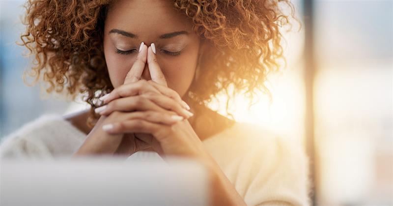 Woman thinking at laptop