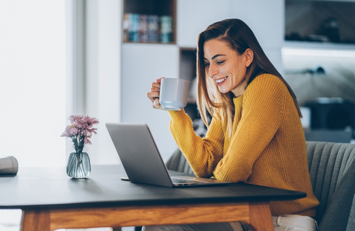 Smiling investor looking at laptop