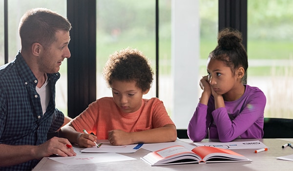 Man helping kids with homework