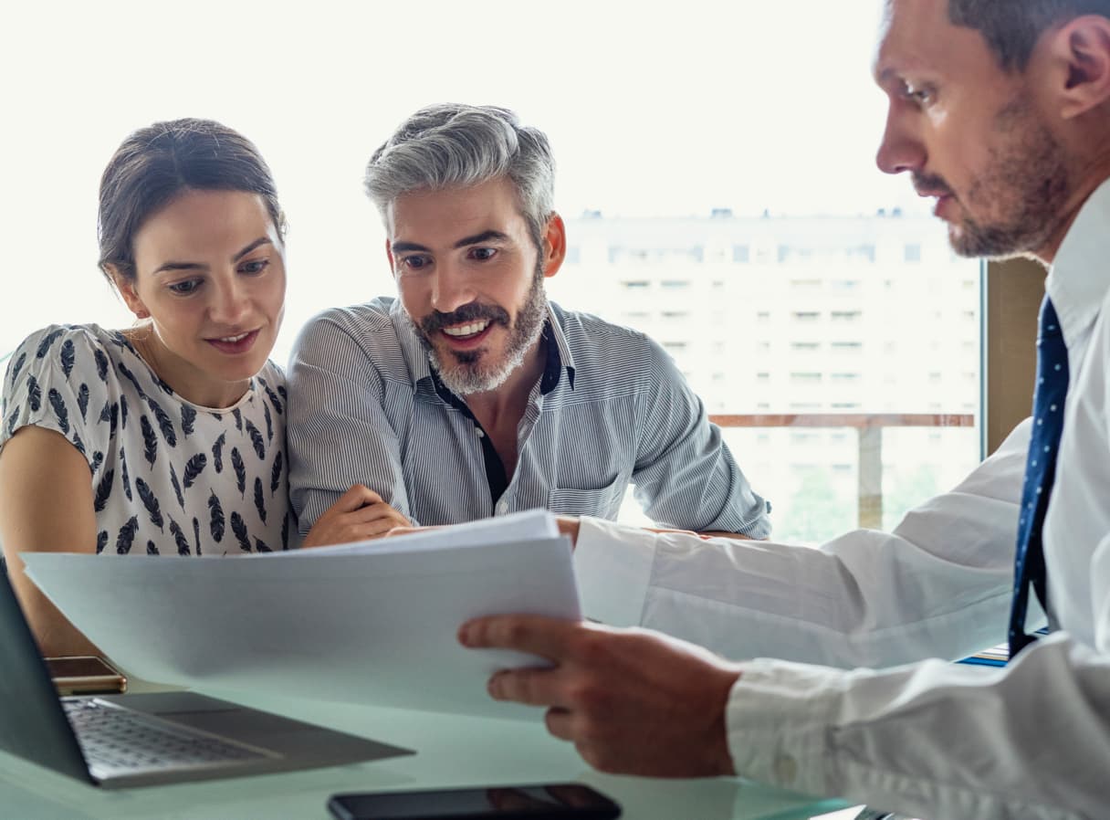 Financial expert showing a report to a couple.