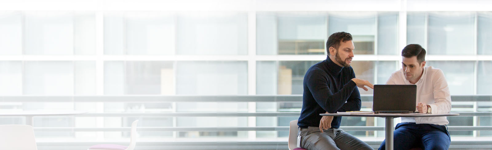 Businessman talking to businessman at a table