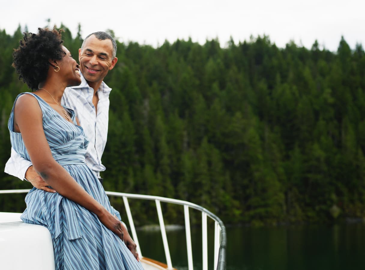 Couple looking at each other outside on a boat.